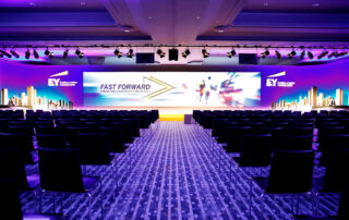 Balanced event stage design with LED screens and wood scenography