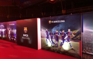 Double-sided illuminated event signage guiding attendees at a Barcelona congress.